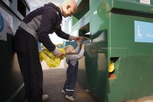 Child and father recycling
