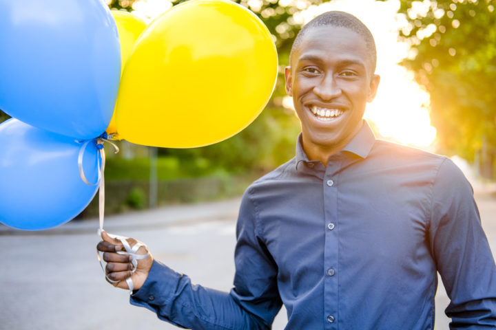 Man with balloons celebrating