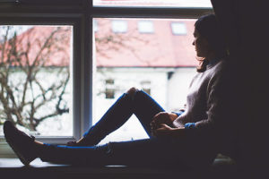 Woman sitting in window