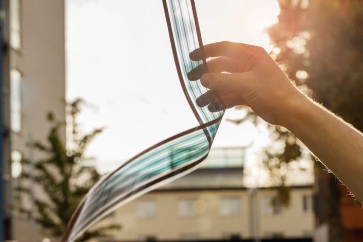 Person holding Epishine's solar cell strip in the sunlight