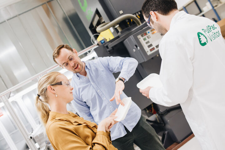 People looking at PulPac packaging