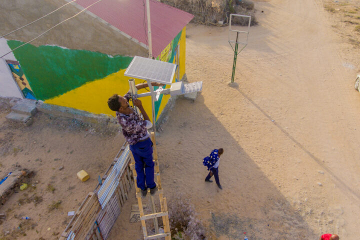 Man installing solar-driven light