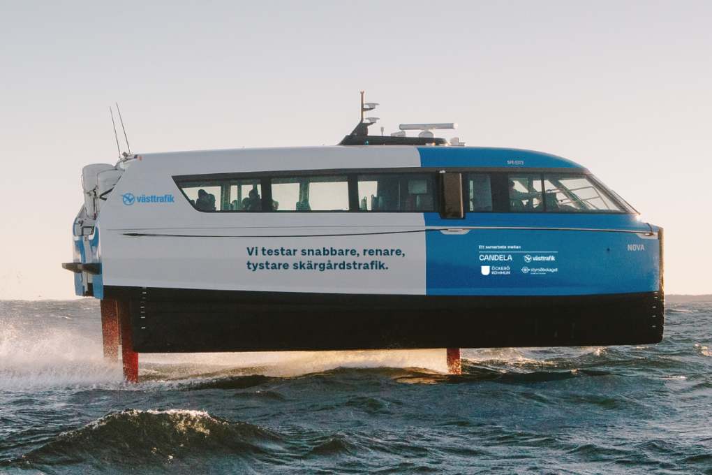 Blue and white electric ferry on the water